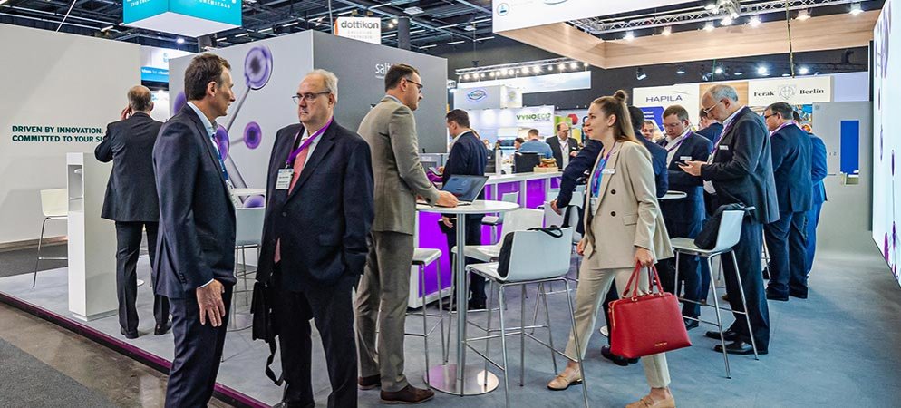 Exhibitors and visitors meet near an exhibit stand at Chemspec Europe